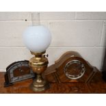 Two clocks and an oil lamp