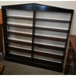 An antique stained pine open bookcase