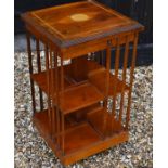A yew veneered and inlaid revolving bookcase