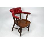 An antique provincial elm seated captains chair