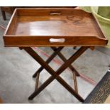 A mhogany tray top butlers table on folding base