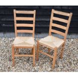 A set of six beech/light oak ladderback dining chairs