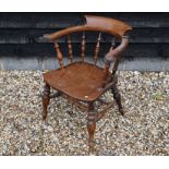 An antique oak and elm spindle back captain's chair