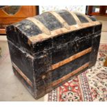 An antique wood and metal bound dome top trunk