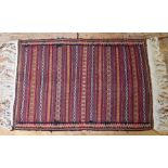 A geometric multi-coloured geometric design Sumak rug