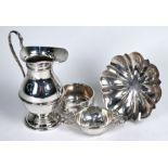 A silver cream jug, tea strainer and small dish