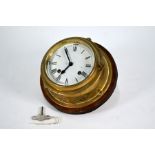 A vintage brass bulkhead clock