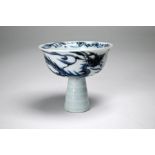 A Chinese Yuan or Ming style porcelain blue and white stem cup painted with a dragon