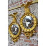 A handed pair of Georgian style giltwood framed eagle surmounted convex mirrors (2)