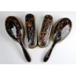 Two pairs of silver, tortoiseshell and piqué-work brushes