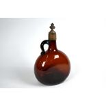 An antique brown glass wine bottle of flattened globular form