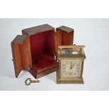 A French Art Deco brass travel alarm clock