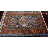 A small old red ground Kurdish rug