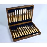 An oak-cased set of twelve silver fish knives and forks