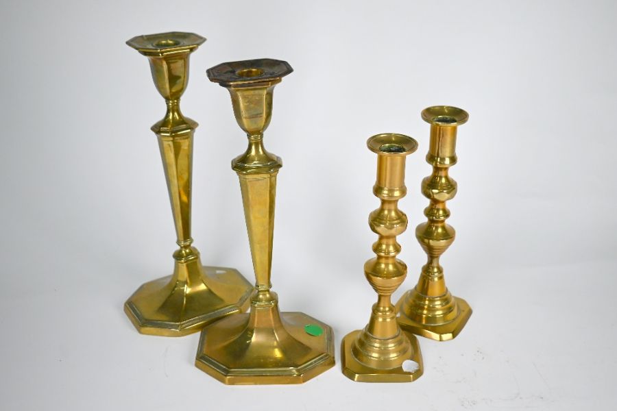 Two pairs of 19th century brass baluster candlesticks