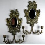 A pair of cast brass girandole mirrors