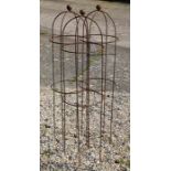 A trio of weathered steel ball head garden obelisks, 115 cm x 30 cm