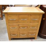 A small modern oak nine drawer chest