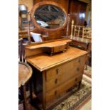 An oak dressing chest with oval mirror