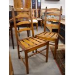 A set of four Ercol elm ladder-back dining chairs