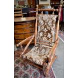 An early 20th century oak framed American rocking chair