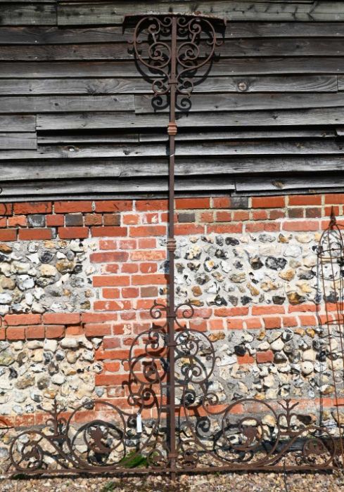 An antique scrolling wrought iron veranda support, 260 cm high