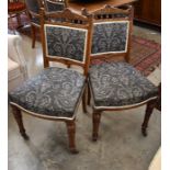 A set of six Edwardian carved oak dining chairs