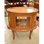 An oval hardwood and glazed tray top vitrine