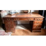 A large mahogany twin pedestal desk