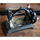 Antique cast irom gilt-decorated hand sewing machine