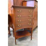 An Edwardian walnut inlaid four drawer music cabinet