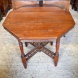 An Edwardian octagonal walnut centre table on cross supports