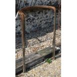 A bundle of ten large curved weathered steel plant supports, 104 cm x 58 cm