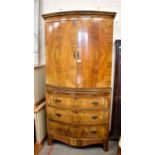 A mahogany bowfront cabinet on chest