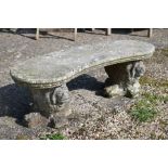A weathered and reconstituted cast stone garden bench