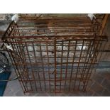 An old French wrought metal and strapwork wine cage/wine rack