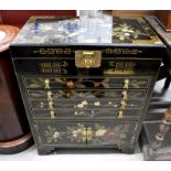 An Oriental black lacquered canteen cabinet