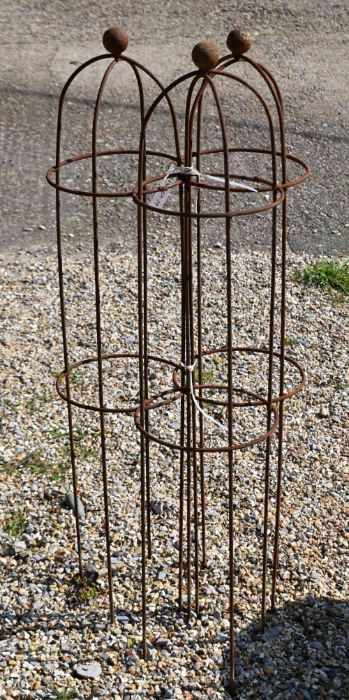 A trio of weathered steel ball head garden obelisks, 103 cm x 24 cm