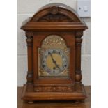 A German carved walnut cased bracket clock