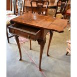 A reproduction walnut drop leaf side table