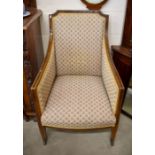 An antique walnut framed salon armchair with floral upholstery