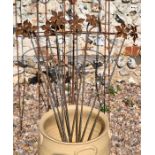 Ten floral cast weathered steel garden stakes, 85 cm