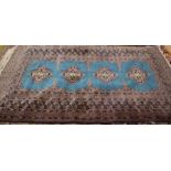 A Turkoman design teal ground rug
