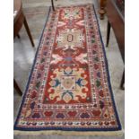 A Turkish geometric design red ground runner