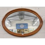 A large bevelled oval wall mirror