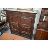 An 18th and 19th century panelled oak cupboard