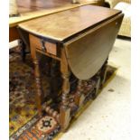 A small oak drop leaf table with end drawer and gate-leg turned supports