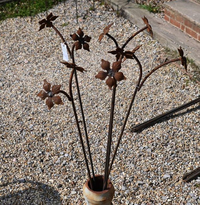 Five floral cast weathered steel garden stakes, 130 cm