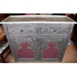 A Moroccan style pressed metal and leather effect cabinet