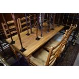 A rectangular pine refectory dining table and four chairs